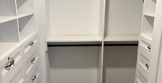 Walk-in closet system with white finish and Allegra drawer fronts